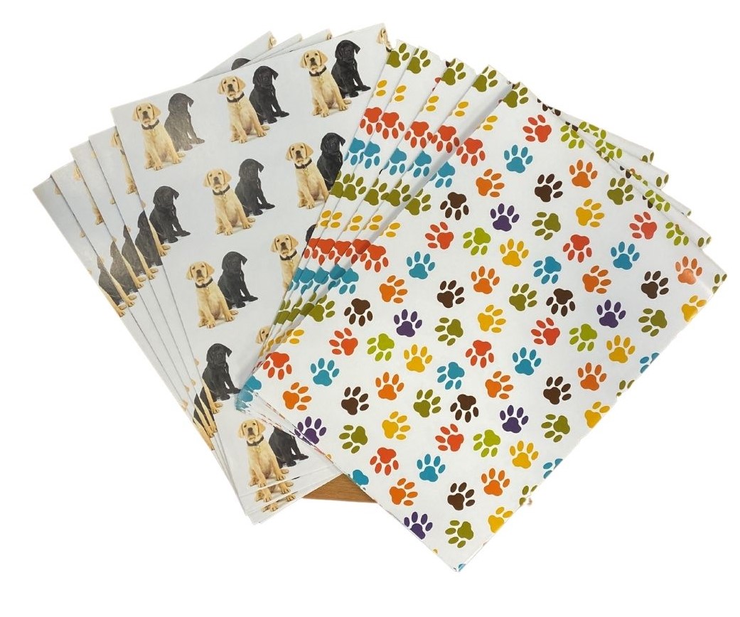 Gift wrap featuring paw prints and two labradors – one yellow and one black
